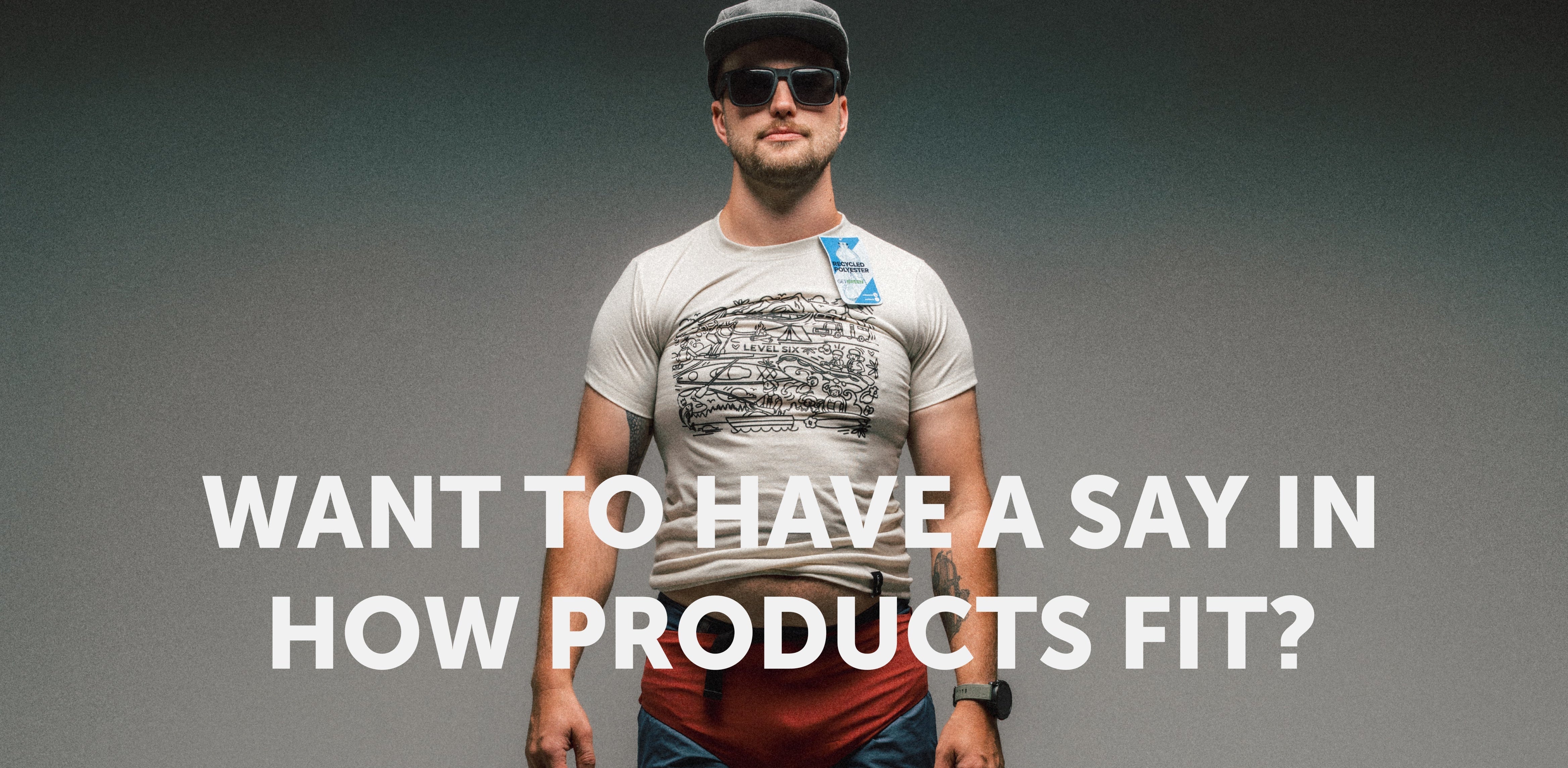 A paddler standing against a grey wall in a Level Six recycled polyester tee, with the words: Want to have a say in how products fit?